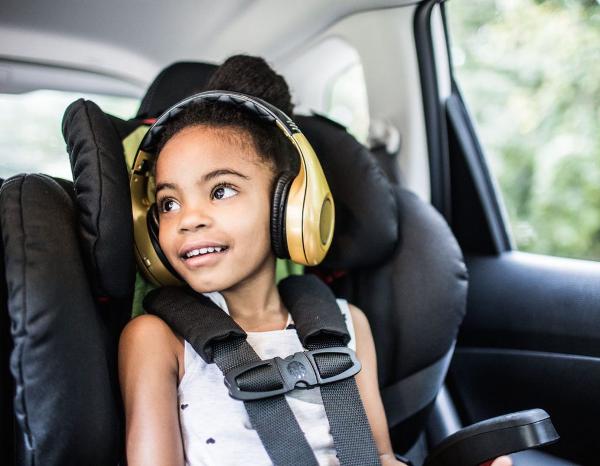 Happy Black Girl Listening to Audiobook in Car