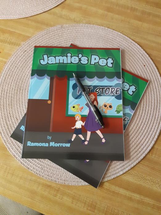 Two Jamie’s Pet Books and Pen on Pink Placemats