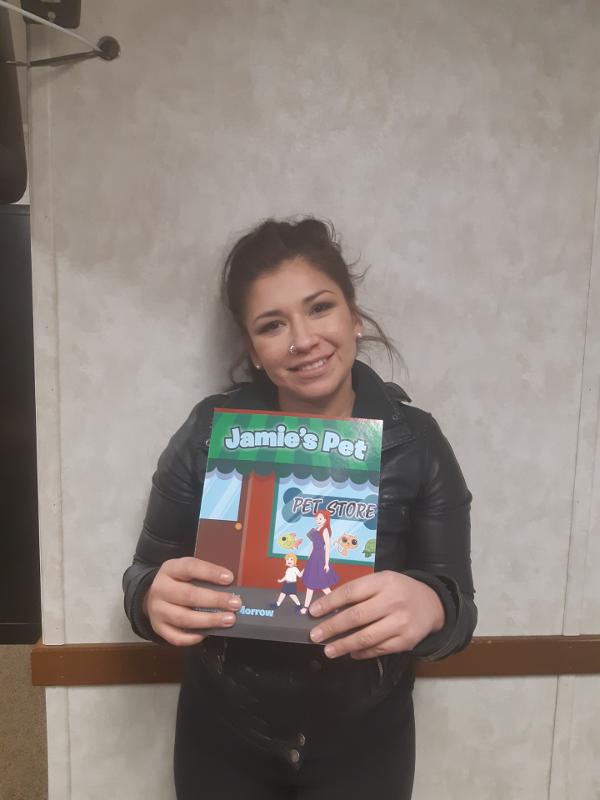 Cheyanne Massen Holding A Copy Of Jamie's Pet. Children's Book